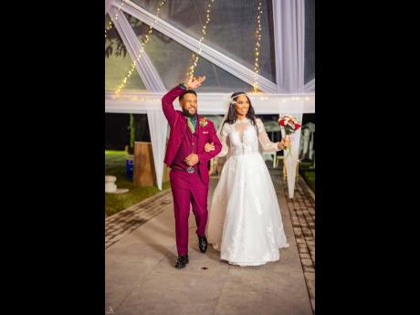 Lights, camera, passion: The pair make a grand entrance into the wedding reception as newlyweds.