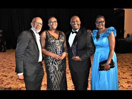 Sonia Clarke Bowen (second left), managing director of RSD Shipping Agency Jamaica Limited, is joined by (from left) Wesley Tennant of K&K Supplies; Oneil Haye, regional director at Eastern of RSD Shipping; and Cynthia Tennant of K&K Supplies as they celeb