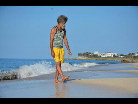 Fisherman Herman Wong takes a stroll on the beach.