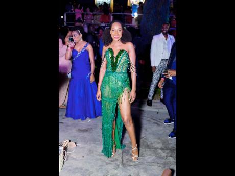 Digicel Partner Manager Joni McCalla looks stunning in her green, thigh-high split gown.
