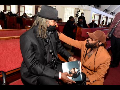 Tarrus Riley greets Sly Dunbar during the funeral service for the late Robbie Shakespeare in February of this year. Saturday’s Tarrus and Friends will feature a special tribute to music legends including Shakespeare who passed in December 2021. 
