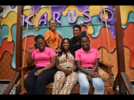 Karuso staff gives dancehall entertainer Pamputtae and Gleaner reporter Steffi a warm welcome; sandwiching them on the swing are Jamila Lewis (left) Taneishia Richards (at back) and Shieed Christopher.