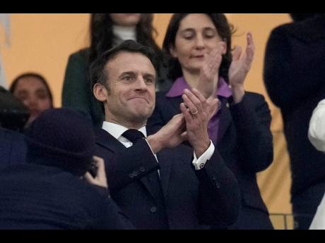 France’s President Emmanuel Macron applauds at the start of the World Cup semifinal football match between France and Morocco at the Al Bayt Stadium in Al Khor, Qatar, yesterday.
