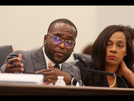 Senator Shevrin Jones, D-West Park, asks a question as Senator Rosalind Osgood, D-Tamarac, looks on during the Committee on Fiscal Policy meeting on December 12 at the Capitol in Tallahassee, Florida, as lawmakers consider ways to shore up the state’s st