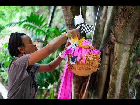 Edwards mounts a personalised piñata for a birthday party.
