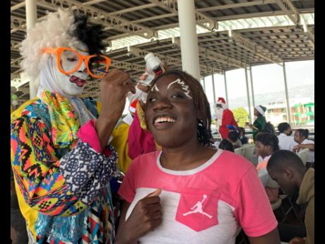 David the Clown paints the face of a member of the disabled community, who, along with scores of others, was fetêd on Thursday by the Sanmerna Foundation and partners during their annual Christmas treat for disabled children.
