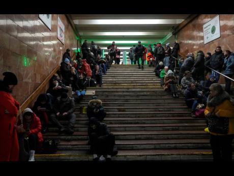 People rest in a subway station, being used as a bomb shelter during a rocket attack in Kyiv, Ukraine today. Ukrainian authorities reported explosions in at least three cities today, saying Russia has launched a major missile attack on energy facilities an