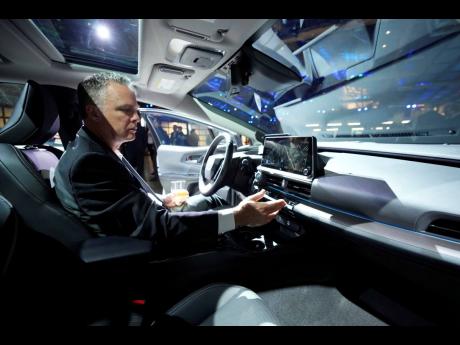Jason Allan, a writer with Kelley Blue Book, looks at the interior of the 2023 Toyota Prius.