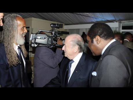 Allan ‘Skill’ Cole (left) meeting FIFA president Sepp Blatter (centre) with Captain Horace Burrell at a Jamaica Football Federation cocktail reception at the Terra Nova Hotel on Waterloo Road in St Andrew.
