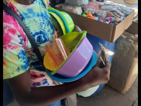 Denise, a struggling mother of five, says she tries not to become too overwhelmed by her circumstances as she sells plastic kitchenware on the streets of Kingston to provide for her family.