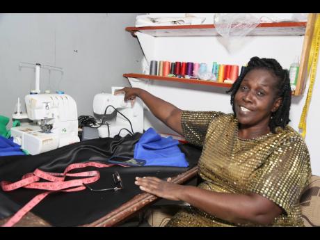 Faith Nembhard, Pastor of Longsyme Church of Prayer and Worship in South Manchester around one of her sewing machines. Pastor Nembhard who taught herself how to sew after been robbed while selling in the market in order to take care of her now grown childr
