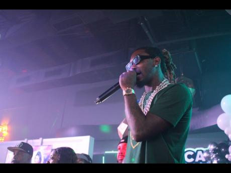 Migos rapper Offset takes the microphone to speak to the guests inside MECA last Friday. 