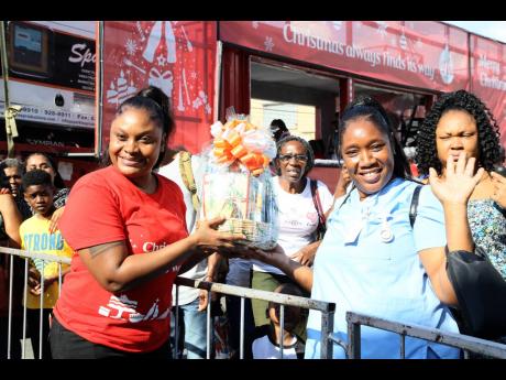 Natoiya Blackwood (second right) collects her prize from Neacha Creighton of Coca-Cola.