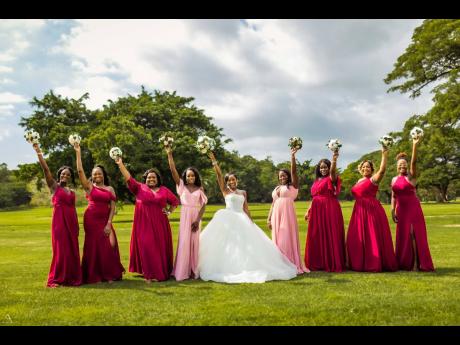 With bouquets in the air, the bride receives nuptial support from her lovely bridesmaids.