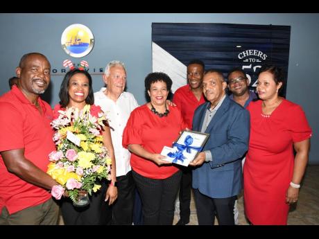 The Seaboard Jamaica team presents Michael Bernard with tokens of their gratitude for his service to the industry.