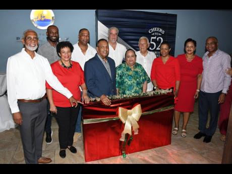 Members of the Shipping Association of Jamaica’s managing committee present a token of appreciation to former president Michael Bernard (centre).