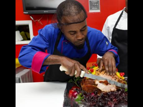 Head Chef at Select Grocers Manor Park, Lishone Ramsden, diligently carving an Arosa Christmas ham.