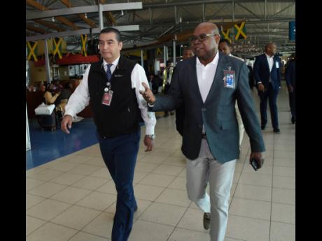 Minister of Tourism Edmund Bartlett (right) and Fernando Vistrain, CEO, PAC Kingston Airport Limited, tour sections of the Norman Manley International Airport (NMIA). The occasion was the Jamaica Tourist Board’s appreciation activity for the NMIA team on