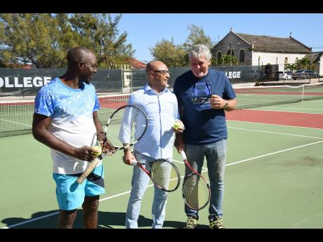 From left: Jordache Deuce, lawn tennis coach at Munro College; Murphy Greg, chairman of the school’s board of governors; and Robert Hale,  Munro College old boy, pose for pictures on the refurbished tennis court at the school.