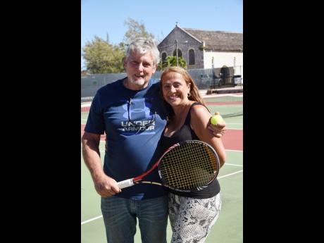 Robert Hale and wife Monica on the refurbished lawn tennis court at Munro College on Wednesday.