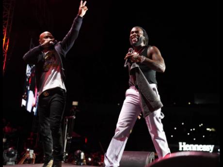 Serani (left), on stage with Burna Boy, at Burna Boy Live held at the National Stadium in Kingston on Sunday. 
