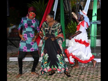 Minister of Culture, Gender, Entertainment and Sport Olivia Grange (centre), dances with members of the Excelsior Performing Arts Society  at the launch of a Jonkunoo Road March and Competition at the Louise Bennett-Coverley Garden Theatre on Hope Road.