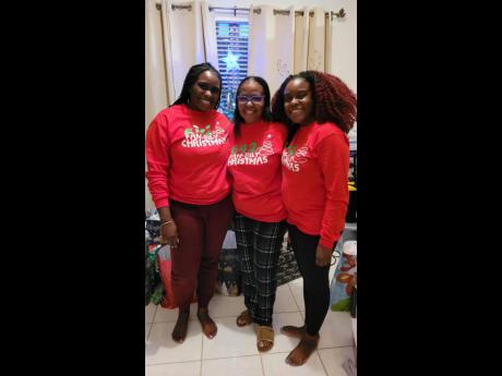 Anneleise Richards (left) and her sister Lauri-Ann lovingly sandwich their aunt, Carla Belnavis, on Christmas day, better known to the family as pajama day in Florida.