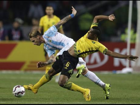 
Jamaica’s Lance Laing attempts to tackle Argentina’s Lucas Biglia during a Copa America Group B game at the Sausalito Stadium in Vina del Mar, Chile, on August 20, 2015