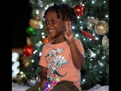 Four-year old Zaiden Borris enjoys  the city's tree-lighting ceremony.