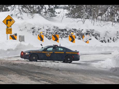 A New York State Trooper car block the entrance to route 198 after a winter storm rolled through Western New York on Tuesday.