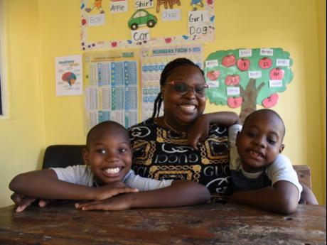Shakira Bryan Davis (centre) and her sons Samuel (left) and Caleb (right). Both children, who are suffering from autism and attention deficit hyperactivity disorder (ADHD), have now been enrolled at the Ensom City Primary School.