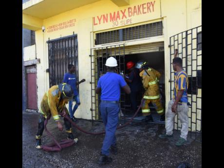 Firemen moving their equipment from LynMax Bakery along Slipe Road in Kingston on Wednesday after they extinguishing a fire at the facility.