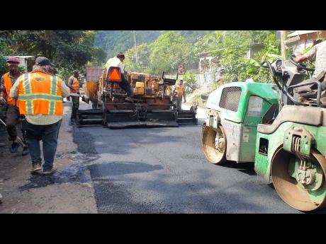 A work crew conducting a final rolling of the road surface near Broadgate in St Mary.