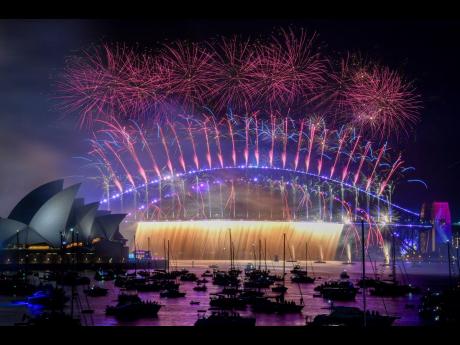 Fireworks explode over the Sydney Harbour Bridge as New Year celebrations begin in Sydney, Australia.