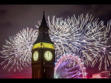 Fireworks light up the sky over the London Eye and the Elizabeth Tower, also known as ‘Big Ben’, in central London during the New Year celebrations.
