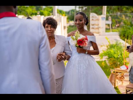Taralee was escorted up the aisle to her soon-to-be husband by her godmother, Olivia McCalla.