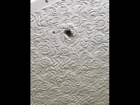 

This photo contributed from a social media post shows what appears to be a bullet hole in a ceiling.