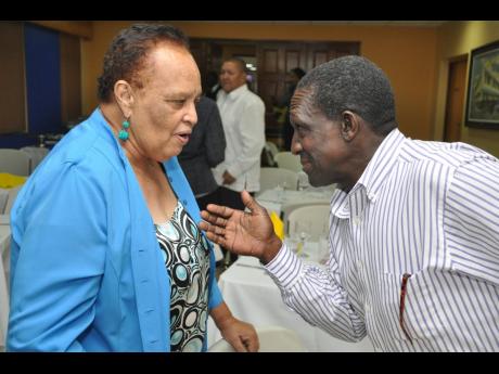 PAJ life member Barbara Gloudon (left) has a chat with Winston ‘Babatunde’ Witter at the Press Association of Jamaica Veteran’s Luncheon at J. Wray and Nephew, Spanish Town Road on Wednesday November 26, 2014.