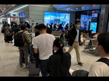 Passengers prepare to board a flight at the airport in north-central China’s Jiangxi province on November 1, 2022. The Chinese government said on December 27, 2022 that it will start issuing new passports as it dismantles antivirus travel barriers.