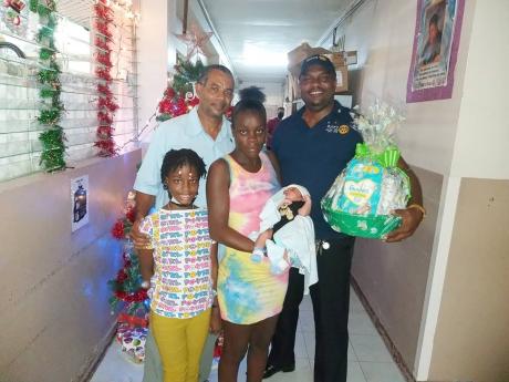Sherdian Cooke, (centre) with her newborn Rajay Hessing and Khaylie Guscott, (left). Also sharing the spotlight from left are; past president of the Rotary Club of Savanna La Mar, Sheldon Edwards and Demerce Guscott, the Club’s secretary, and incoming pr