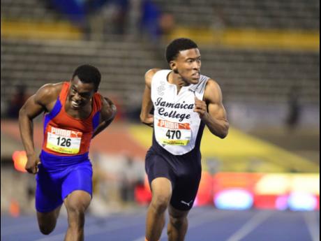 Mark Anthony Miller (right) of Jamaica College wins last year’s Boys and Girls’ Athletics Championships  Class Two boys 100 metres final ahead of Camperdown’s Jason Lewis.