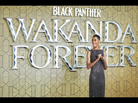 Letitia Wright poses for photographers upon arrival for the premiere of the film ‘Black Panther: Wakanda Forever’ in London, Thursday, November 3, 2022. 