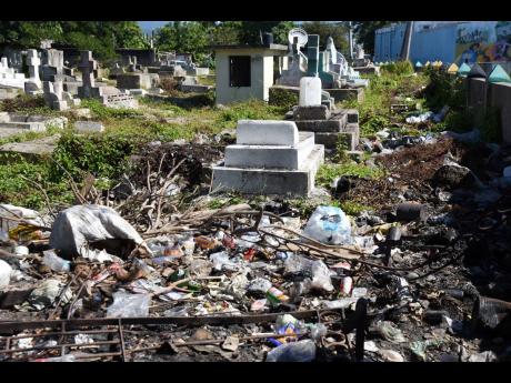 Sections of The No 5 Cemetery in Spanish Town, St Catherine, was recently cleared of bushes, but residents of nearby communities continue to dump waste at the burial ground.
