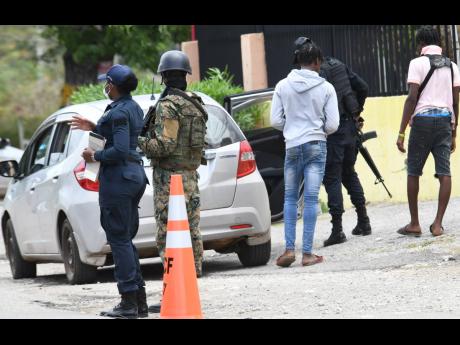 JDF and JCF personnel at a state of emergency checkpoint in St Catherine.