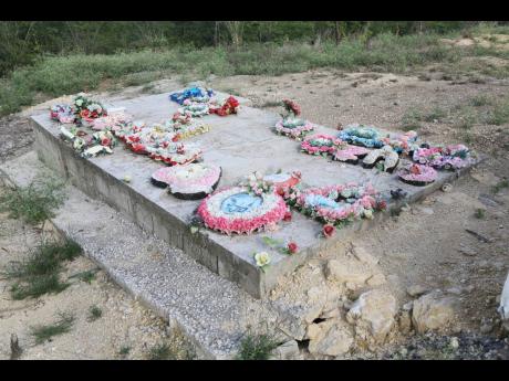 The grave of Kemesha Wright and her four children who were murdered in Cocoa Piece on June 21.