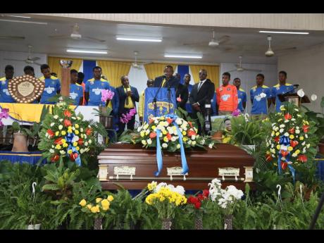 Richard Palmer, manager of Clarendon College’s daCosta Cup team, leads other officials and members of the team in paying tribute to assistant manager Neville ‘Manny’ Peart during the funeral service for the latter last Friday at Clarendon College in 