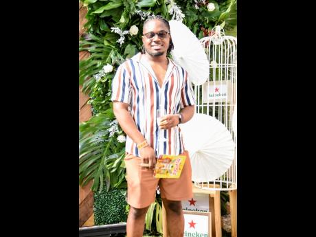 Alex McFarlane shows off his style, pairing his bold stripe shirt with brunch-worthy shorts.