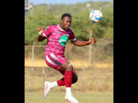 Devonti Hodges of Chapelton Maroons heads clear  during the Jamaica Premier League encounter against Vere United at the Wembley Centre of Excellence on Sunday. 