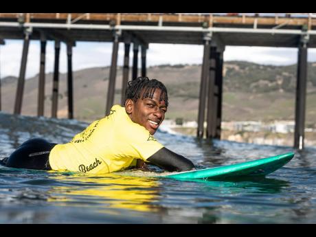 Jamaica’s Nathaniel Bailey gets ready to catch a wave at the ISA World Para Surfing Championship in Pismo Beach California.