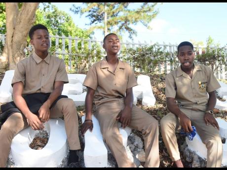 Sixteen-year-old Rushawn Ewears (centre) singing with friends Gareth McIntosh (left) and Javae Lawrence during an interview with The Gleaner at the B.B Coke High School in Junction, St Elizabeth, on Tuesday.